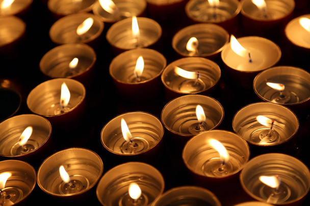candles lit with the warm flame during the religious ceremony - Photo, Image