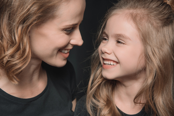 daughter and mother smiling - Foto, afbeelding