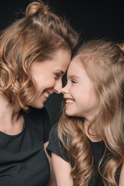 daughter and mother smiling - Foto, Bild
