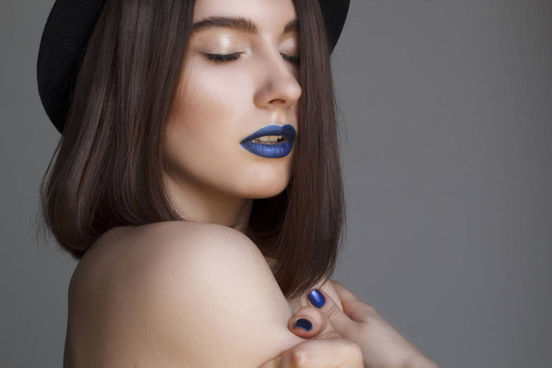 Portrait of beautiful young woman with blue lips and in hat. Bea - Фото, зображення