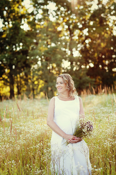 pregnant woman in summer field  - Photo, image