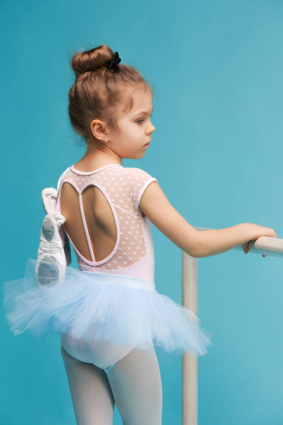 The little balerina dancer on blue background - Foto, imagen