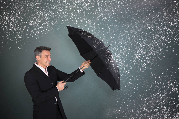 Businessman With Umbrella In Snow - Фото, изображение
