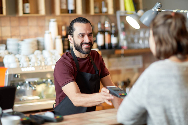 man or waiter with card reader and customer at bar - Photo, Image