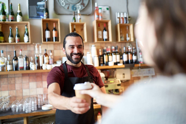 man or waiter serving customer in coffee shop - Фото, зображення