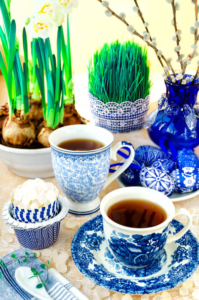 Dekoracje wielkanocne z herbata, cukier, jaja, żonkile, Ropna wierzba, mięty i kiełkowanie nasion w kolorze niebieskim - Zdjęcie, obraz