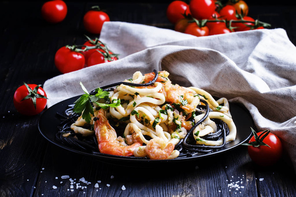 Black pasta with seafood and tomato sauce - Φωτογραφία, εικόνα