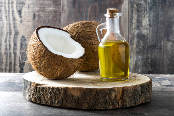 Coconut oil on wooden background - Photo, Image