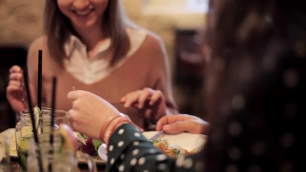 happy friends eating and drinking at restaurant - Felvétel, videó