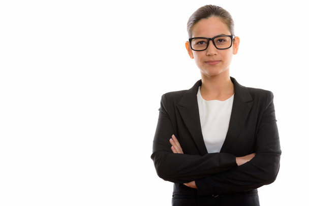 Studio shot of young beautiful businesswoman wearing eyeglasses with arms crossed - Foto, Imagen