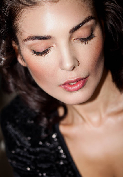 Beautiful woman portrait wearing makeup and looking down - Fotografie, Obrázek
