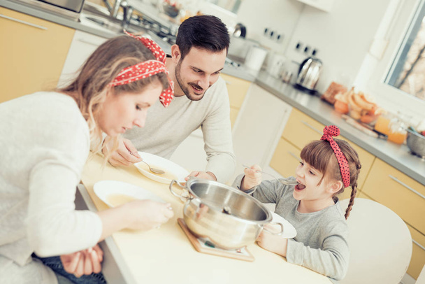 Young family in kitchen  - Fotó, kép
