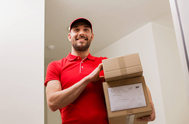delivery man with parcel boxes at customer door - Foto, Imagen