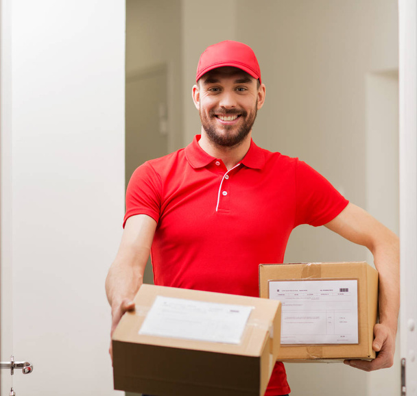 delivery man with parcel boxes at customer door - Fotoğraf, Görsel