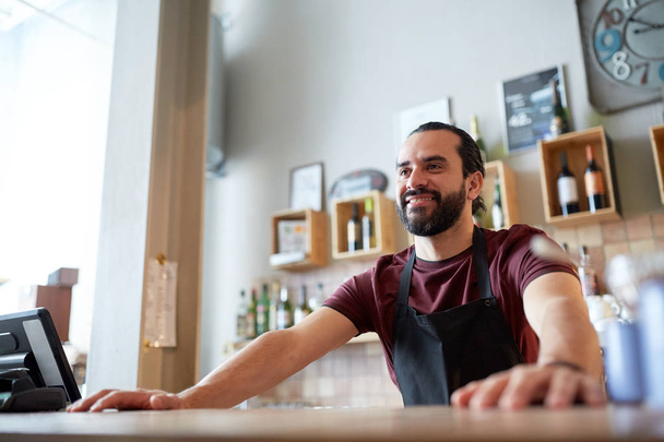 happy man or waiter at bar or coffee shop - Photo, image