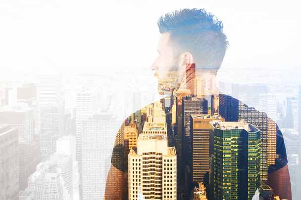 Back view of casual young man on city background. Double exposure. Future concept - Фото, изображение