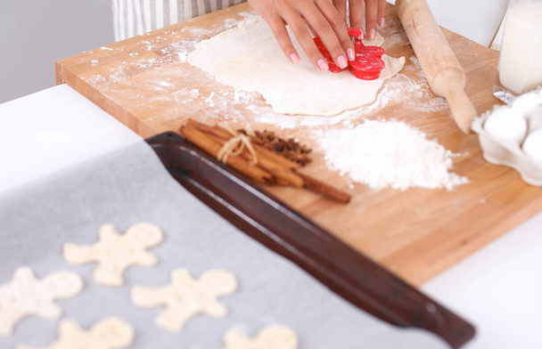 Woman making christmas cookies in the kitchen - Fotó, kép