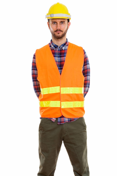 Studio shot of young man construction worker standing - Фото, изображение