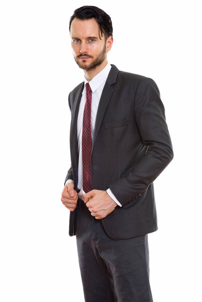 Studio shot of young businessman standing - Foto, afbeelding