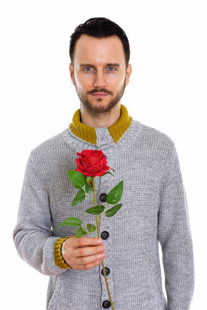 Studio shot of young man holding red rose ready for Valentine's day - Fotografie, Obrázek