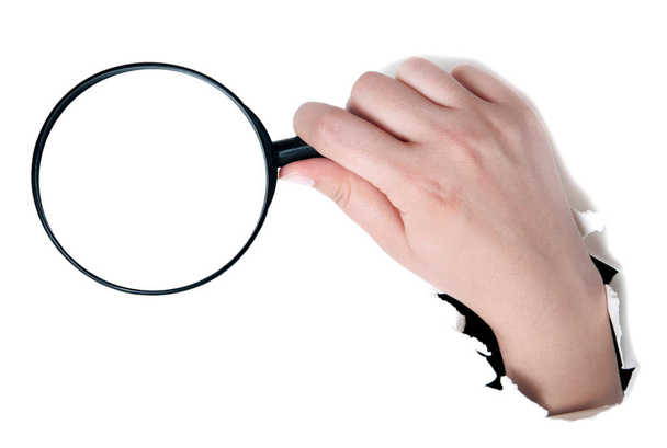 Female hand holding the magnifying glass isolated on white backg - Photo, Image