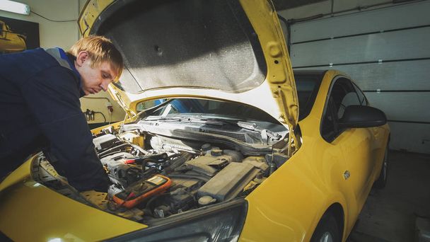 Mécanicien en service automobile - réparation dans le compartiment moteur
 - Photo, image