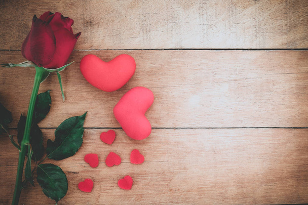 Red roses and heart on wooden background  - Photo, Image