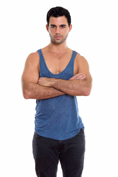 Studio shot of young handsome Hispanic man standing with arms crossed - Foto, Imagem