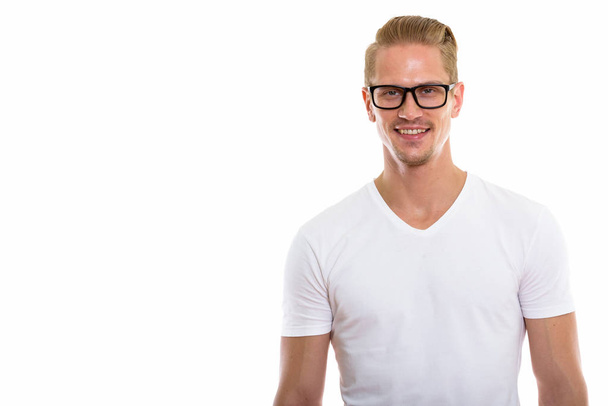 Studio záběr šťastný mladý pohledný muž s úsměvem při nošení brýlí - Fotografie, Obrázek