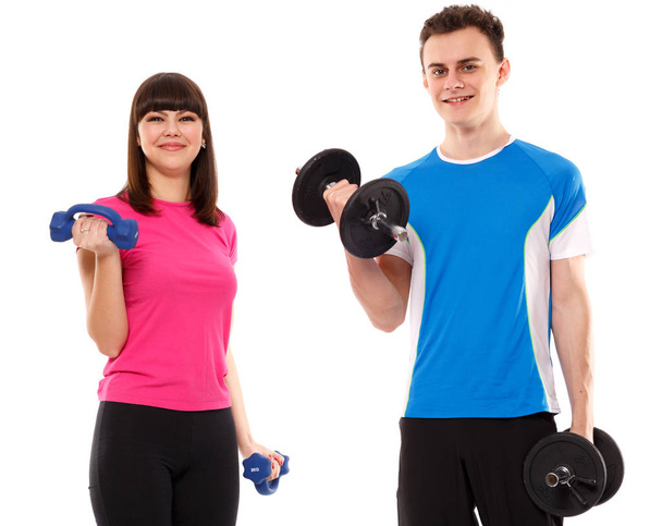 Teenage couple exercising with dumbbells - 写真・画像