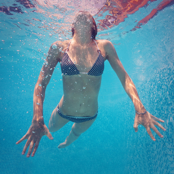 Underwater woman portrait in swimming pool. - Фото, изображение