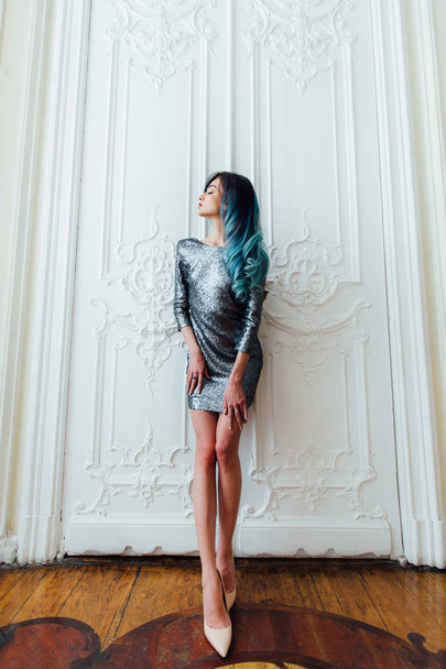 Fashion portrait of gorgeous girl with blue dyed hair long. The beautiful evening cocktail dress. - Foto, imagen