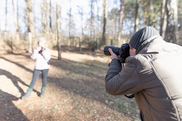 male photographer with the camera on nature. - Valokuva, kuva