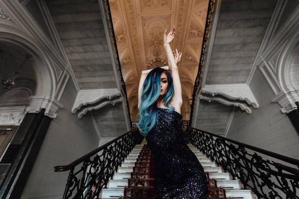 Fashion portrait of gorgeous girl with blue dyed hair long. The beautiful evening cocktail dress. - Фото, зображення