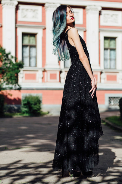 Fashion portrait of gorgeous girl with blue dyed hair long. The beautiful evening cocktail dress. - Fotoğraf, Görsel