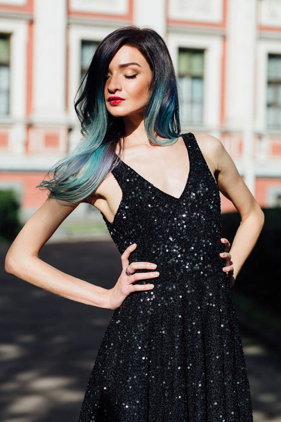 Fashion portrait of gorgeous girl with blue dyed hair long. The beautiful evening cocktail dress. - Photo, Image