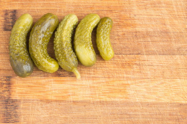 Homemade Pickled Gherkins or Cucumbers Over Rustic Wooden Background - Photo, Image