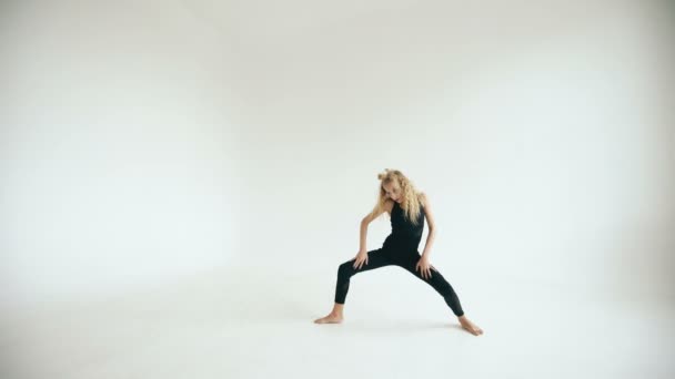 Modern beautiful teenage girl dancer dancing contemporary on white background indoors - Materiaali, video