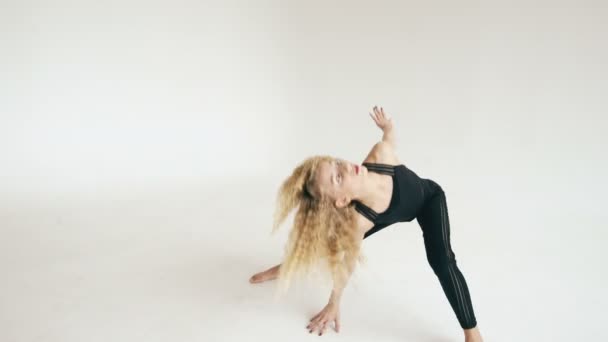 Modern beautiful teenage girl dancer dancing contemporary on white background indoors - Metraje, vídeo
