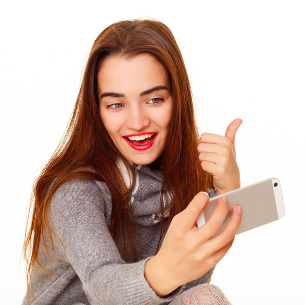 Portrait of young beautiful smiley woman making selfie over whit - Fotó, kép