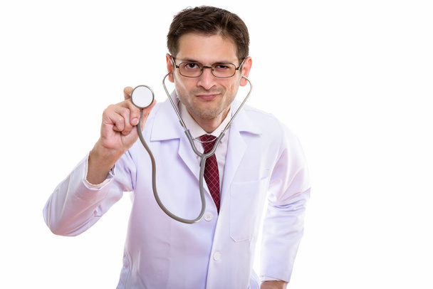 Studio shot of young man doctor using stethoscope - Foto, Imagem