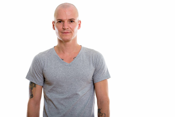 Studio shot of young handsome bald man - Foto, imagen