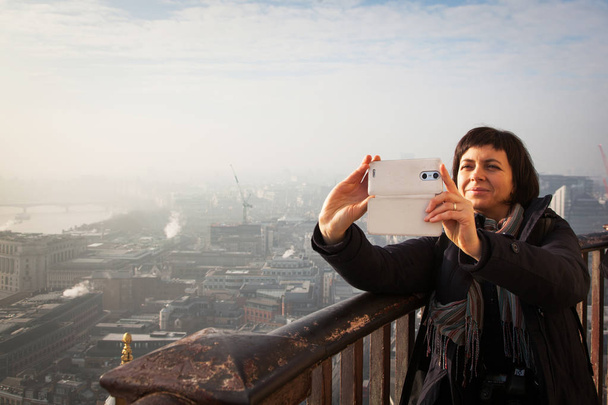 woman taking a selfie from the rooftop of St Paul's Cathedral on - Photo, Image