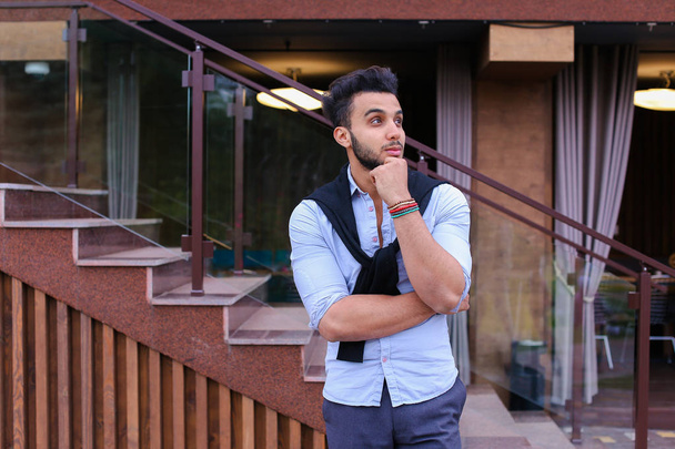 Concentrated stylish young man of Muslim appearance looks from s - Photo, Image