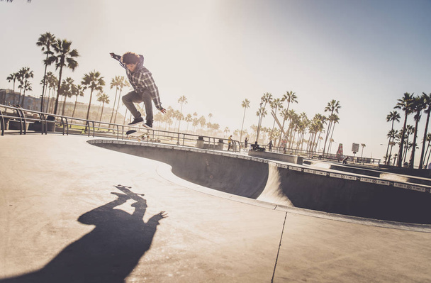 Skateboarder in action outdoors - Fotó, kép