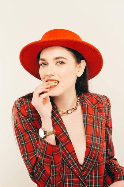 Portrait of young stylish girl. Fashion portret of elegant woman in hat and jacket. Studio shot - Fotó, kép
