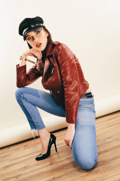 Rock chick in leather jacket, full length. Fashion portrait of elegant woman, studio shot - Фото, зображення