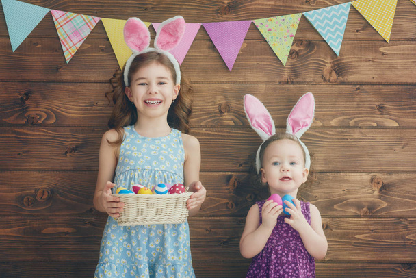 girls are holding basket with eggs - Valokuva, kuva