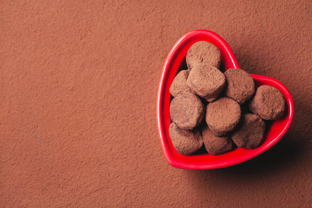 Chocolate truffles in a heart shaped bowl - Foto, Bild