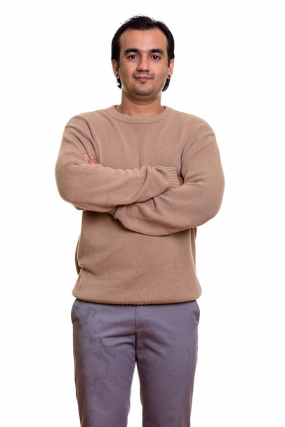 Studio shot of Persian man standing with arms crossed - Photo, Image